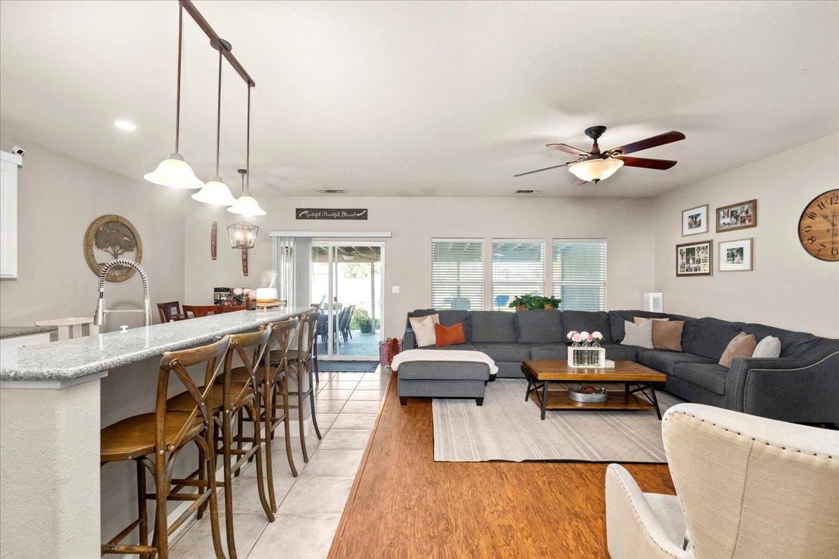 1725 Stonum Road Modesto, CA 95351 - Photo 8 of 34 a living room with furniture kitchen view and a chandelier