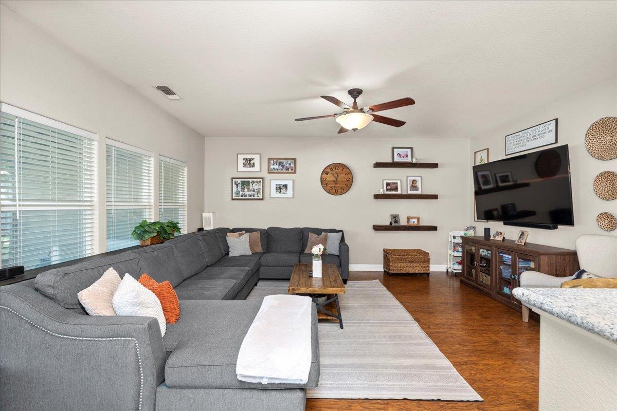 1725 Stonum Road Modesto, CA 95351 - Photo 9 of 34 a living room with furniture and a flat screen tv