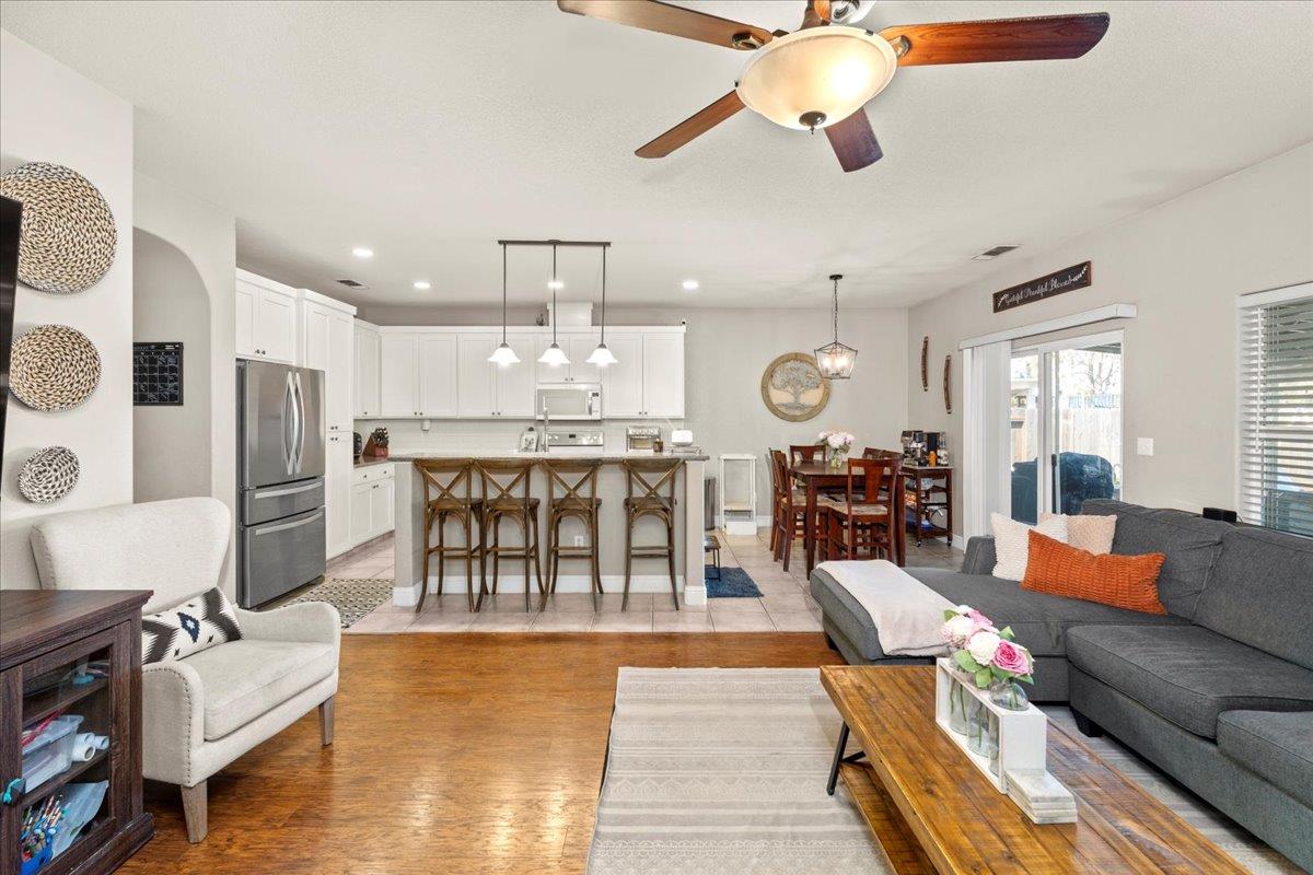 1725 Stonum Road Modesto, CA 95351 - Photo 10 of 34 a living room with fireplace furniture and a chandelier
