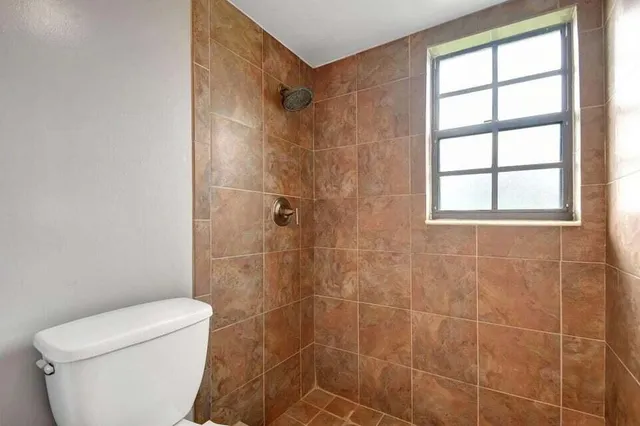 a bathroom with a sink toilet tub and shower