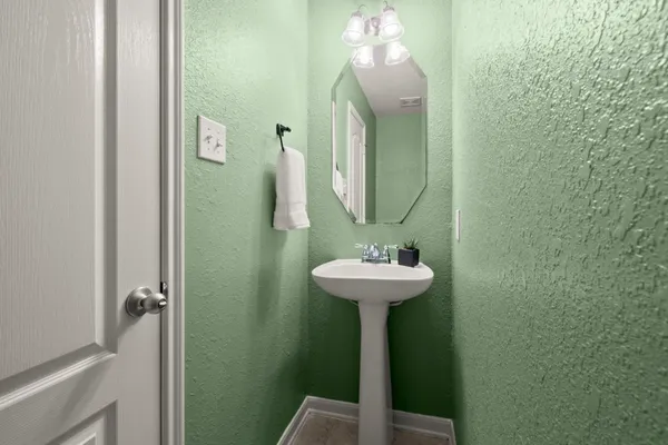 a bathroom with a sink a mirror and shower
