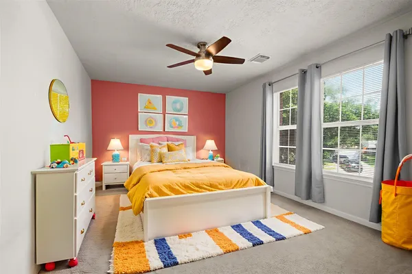 a bed sitting in a bedroom next to a window