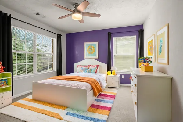 a bedroom with a bed and a large window