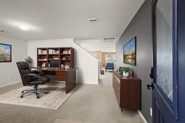 a living room with furniture and a piano