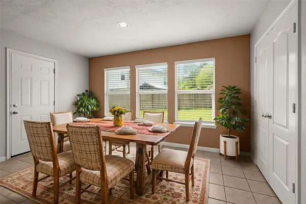 a dining room with furniture and window