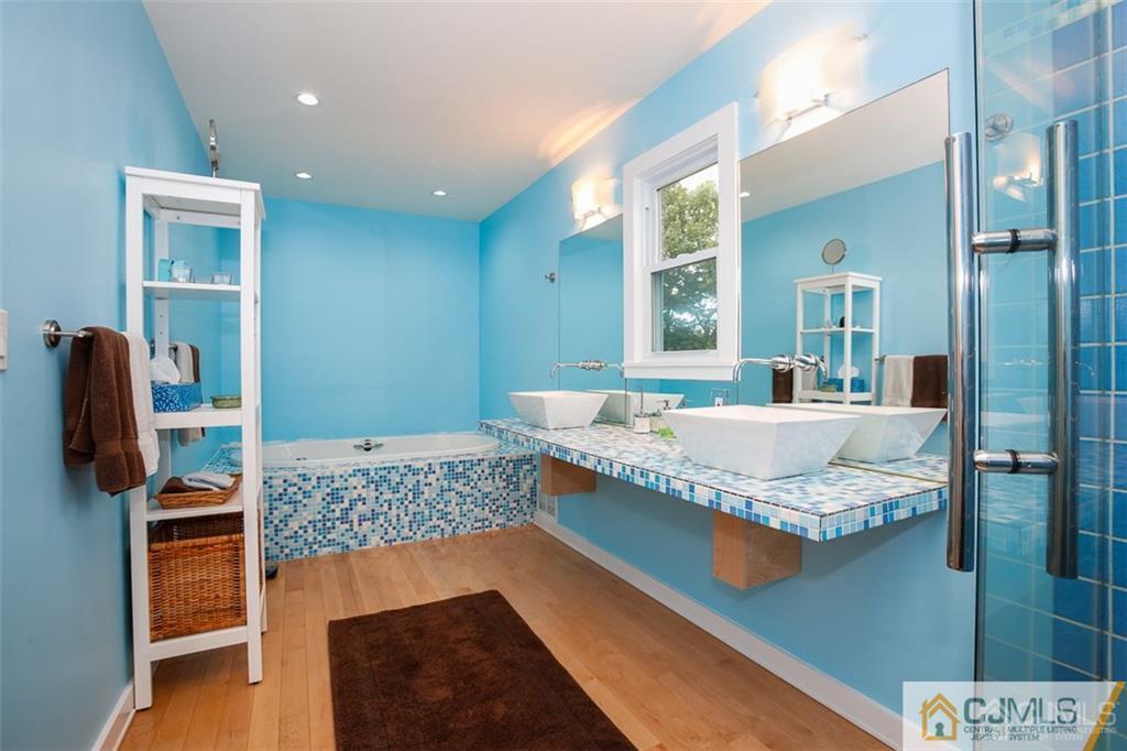 24 Halstead Road New Brunswick, NJ 08901 - Photo 12 of 23 a spacious bathroom with a granite countertop tub and a large mirror