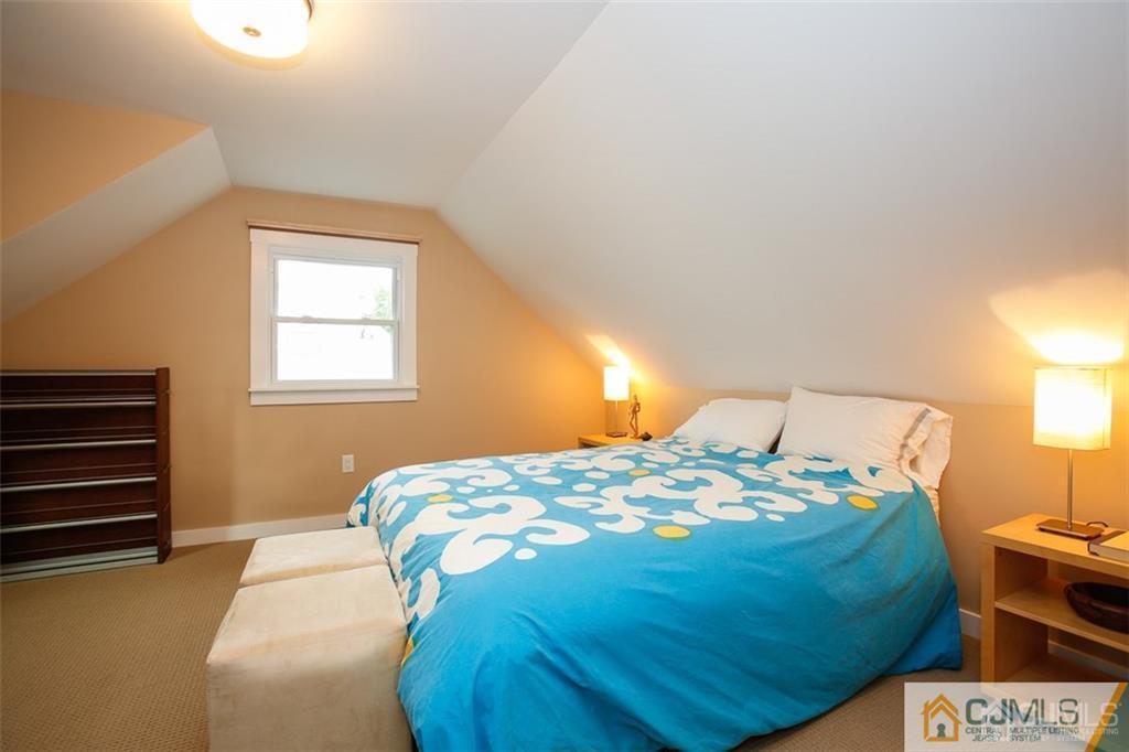24 Halstead Road New Brunswick, NJ 08901 - Photo 14 of 23 a bedroom with a bed and a lamp with window