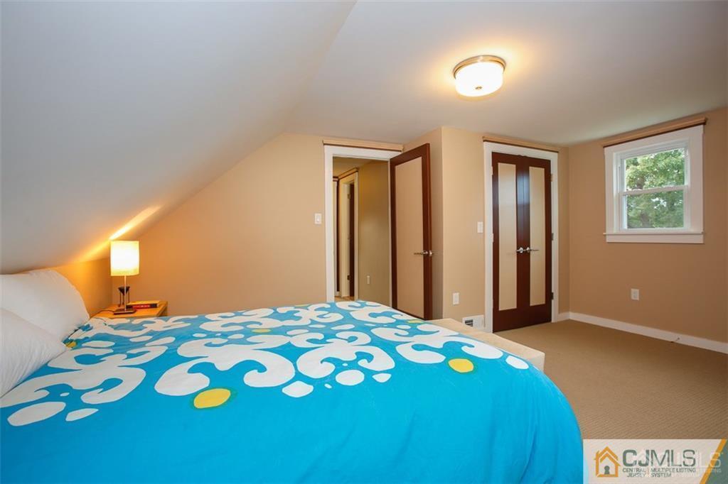 24 Halstead Road New Brunswick, NJ 08901 - Photo 15 of 23 a bedroom with a bed and a lamp on dresser
