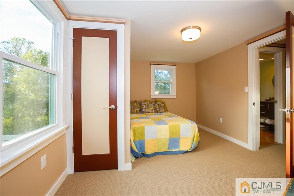 24 Halstead Road New Brunswick, NJ 08901 - Photo 17 of 23 a bedroom with a bed and a large window