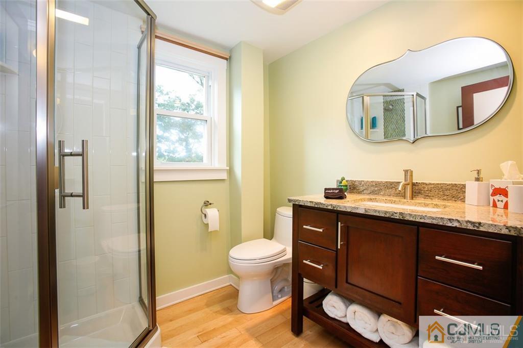 24 Halstead Road New Brunswick, NJ 08901 - Photo 18 of 23 a bathroom with a toilet a sink and a mirror