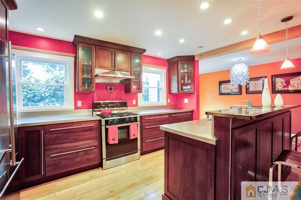 24 Halstead Road New Brunswick, NJ 08901 - Photo 8 of 23 a kitchen with stainless steel appliances granite countertop wooden cabinets and a large window