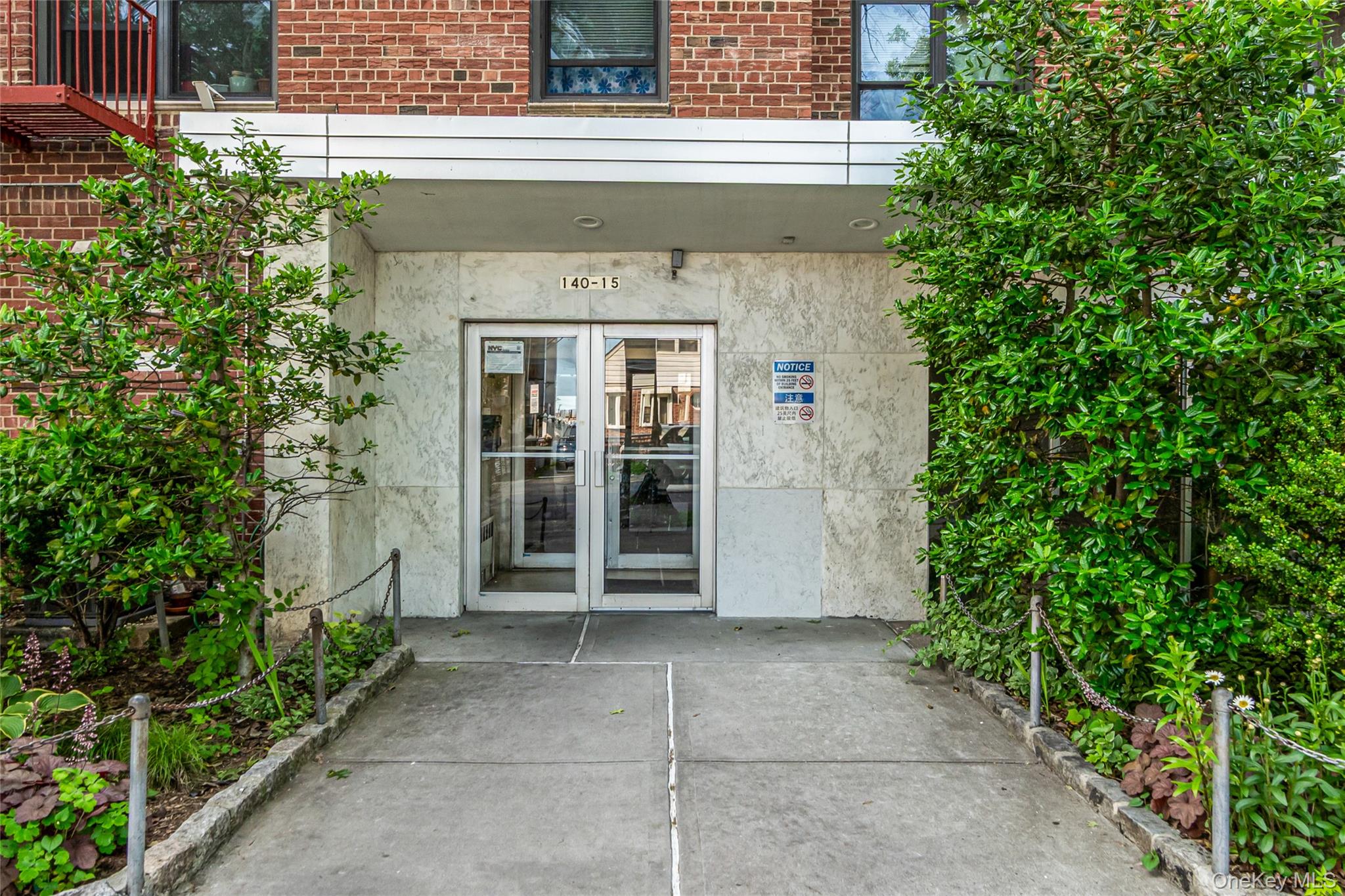 Property entrance featuring french doors, brick siding, and stucco siding