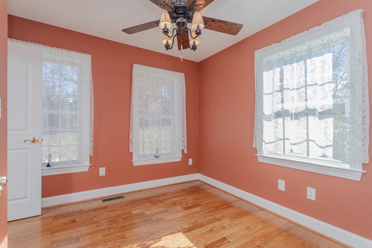 82 Smoky Row Road Staunton, VA 24401 - Photo 13 of 75 a view of an empty room with a window and wooden floor