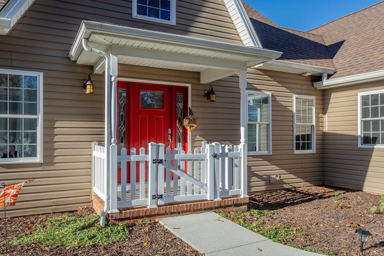 82 Smoky Row Road Staunton, VA 24401 - Photo 75 of 75 a view of a house with a small yard and wooden fence and a large tree