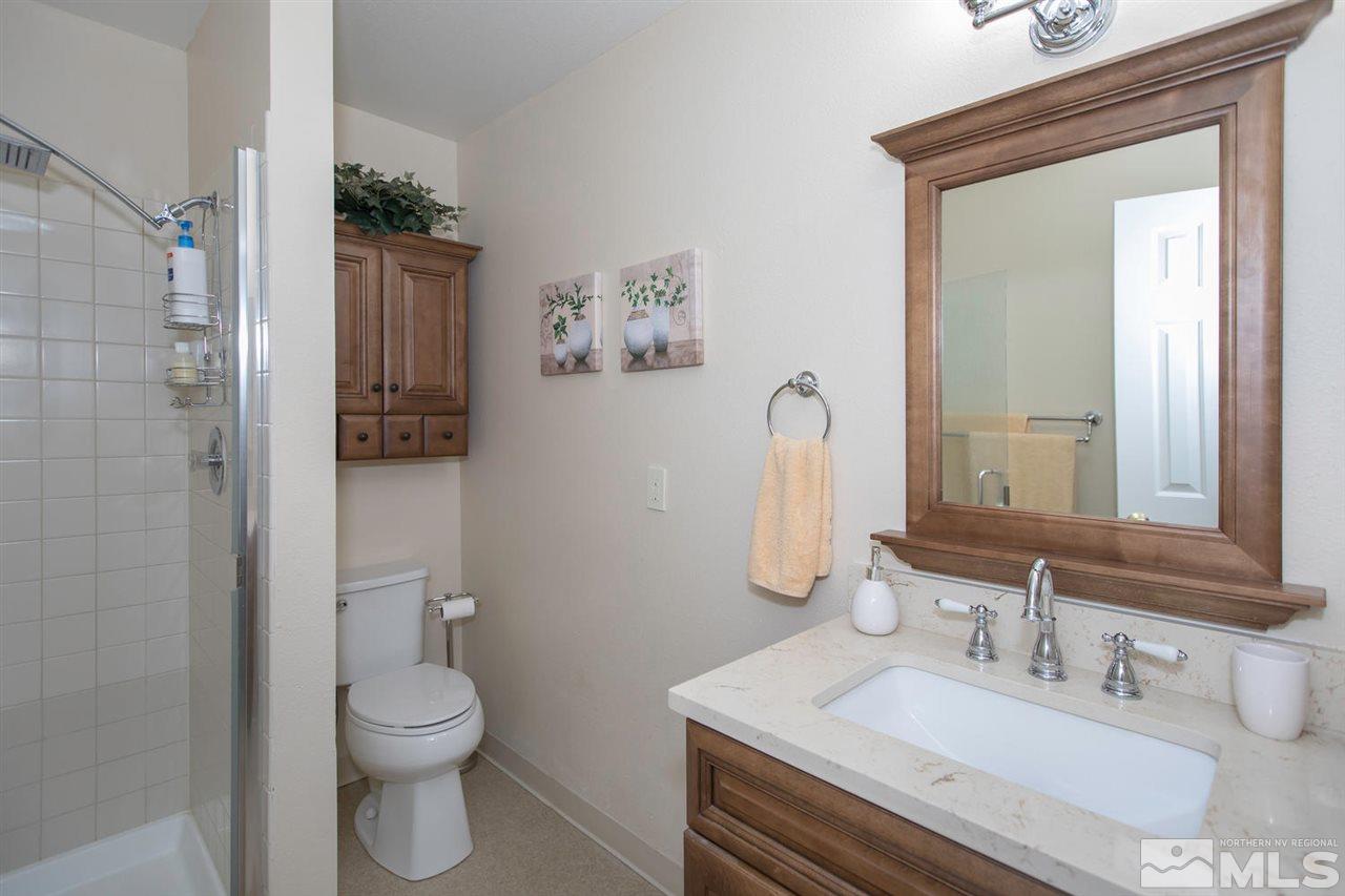 2264 Escalera Way Reno, NV 89523 - Photo 14 of 25 a bathroom with a sink vanity mirror and toilet