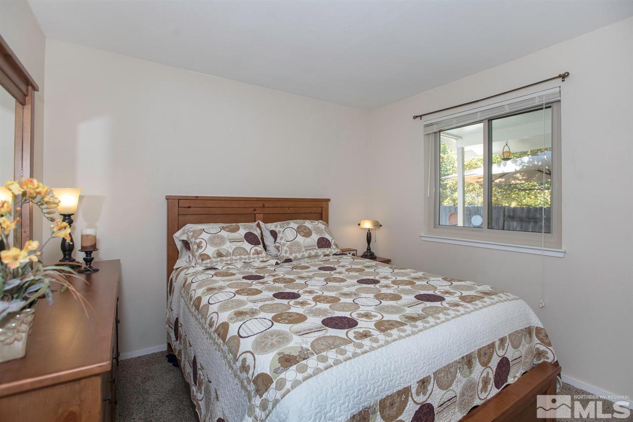 2264 Escalera Way Reno, NV 89523 - Photo 16 of 25 a large bed sitting in a bedroom next to a window