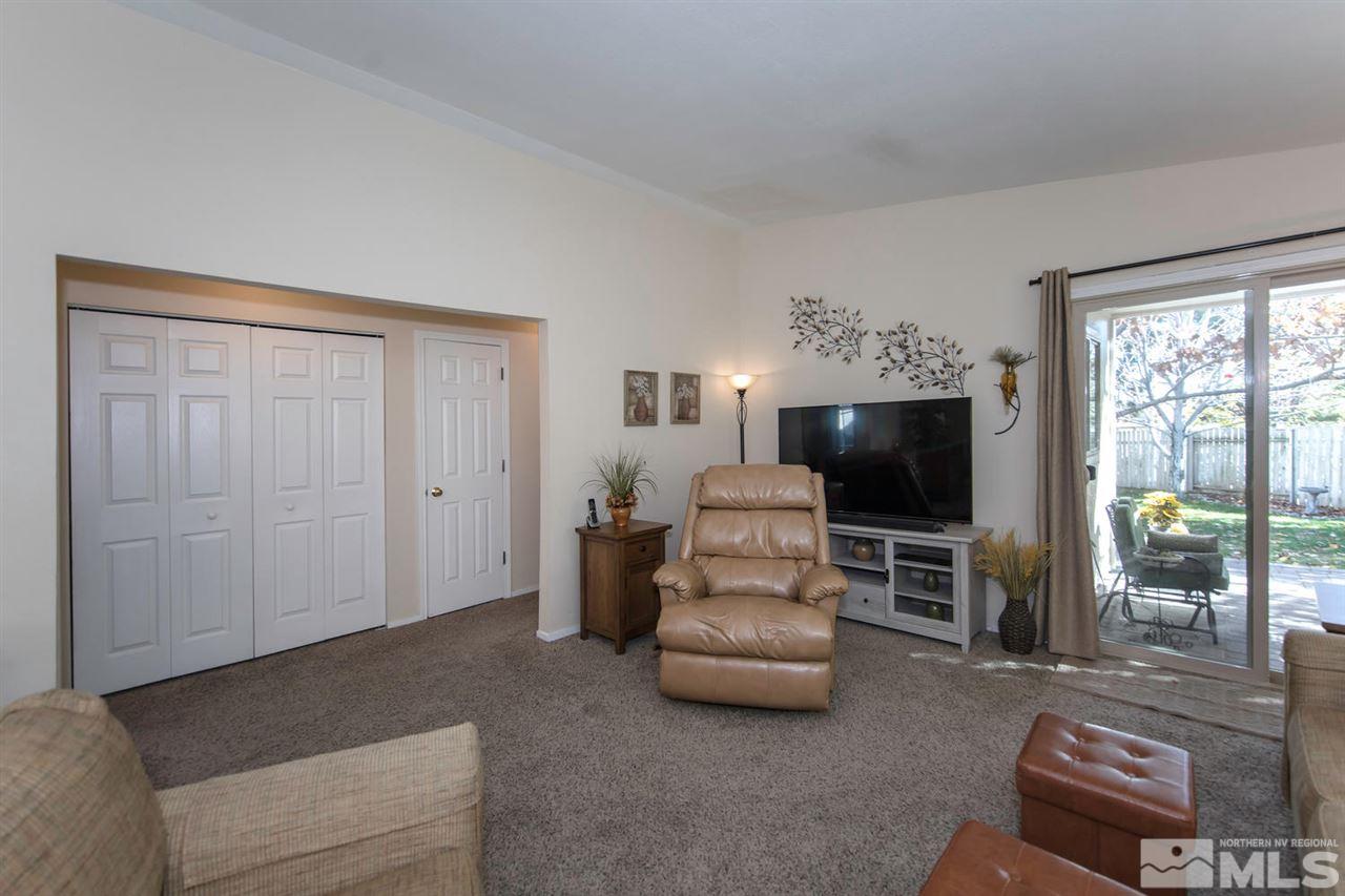 2264 Escalera Way Reno, NV 89523 - Photo 6 of 25 a living room with furniture a flat screen tv and floor to ceiling window