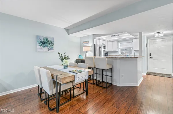 a view of a dining room with furniture and wooden floor
