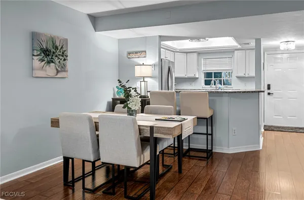 a view of a dining room with furniture and wooden floor