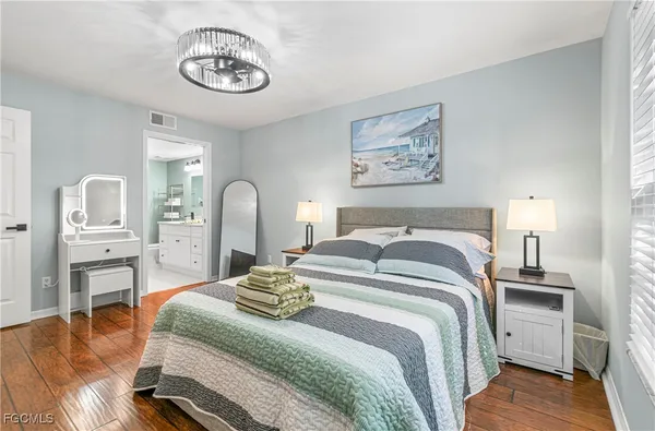 a bedroom with a bed and a chandelier