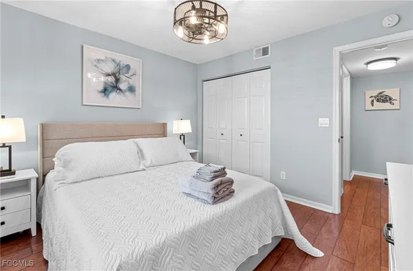 a bedroom with a bed and a chandelier