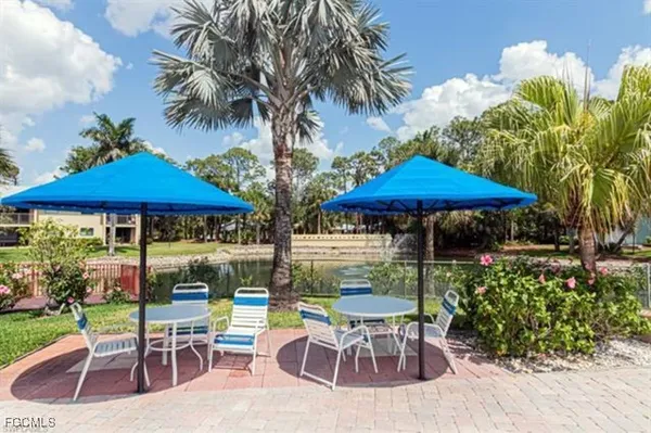 a view of a table and chairs under an umbrella in patio