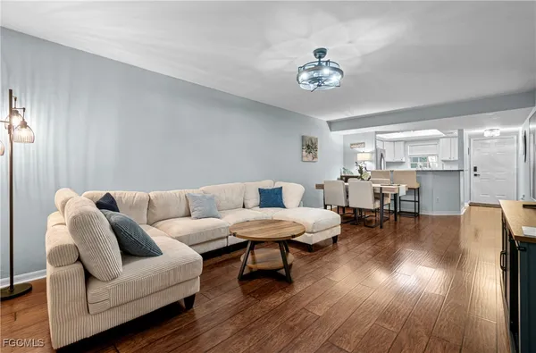 a living room with furniture and a chandelier