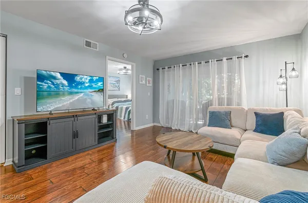 a living room with furniture and a flat screen tv