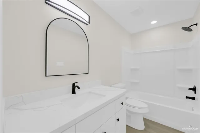 an empty room with a window and a ceiling fan