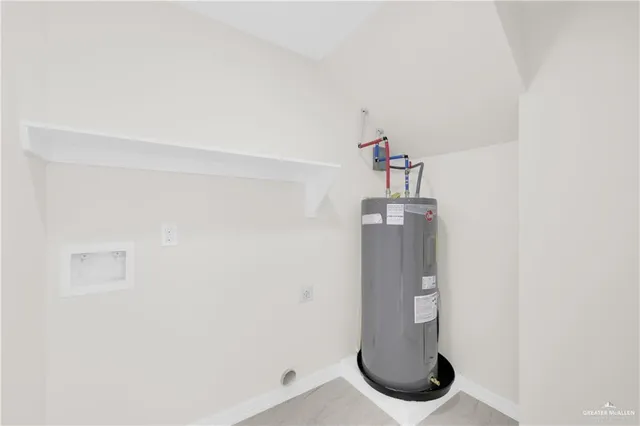 a view of a big room with wooden floor and windows