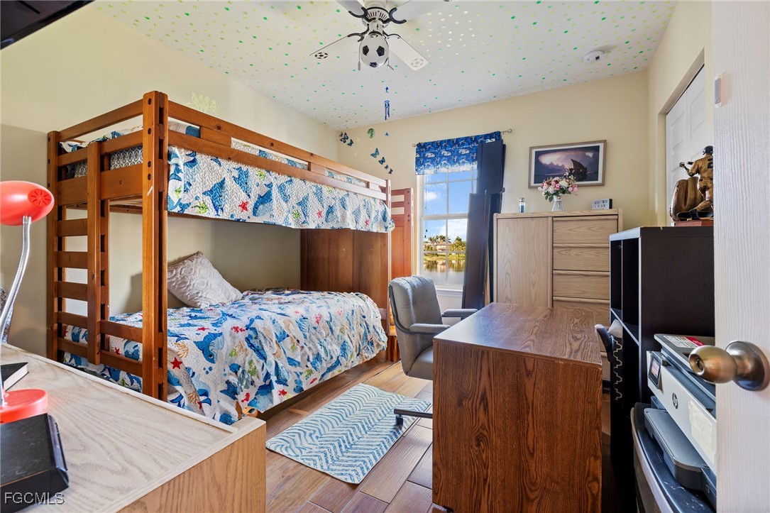 8657 Sumner Avenue Fort Myers, FL 33908 - Photo 22 of 29 a bedroom with a bed and a flat screen tv