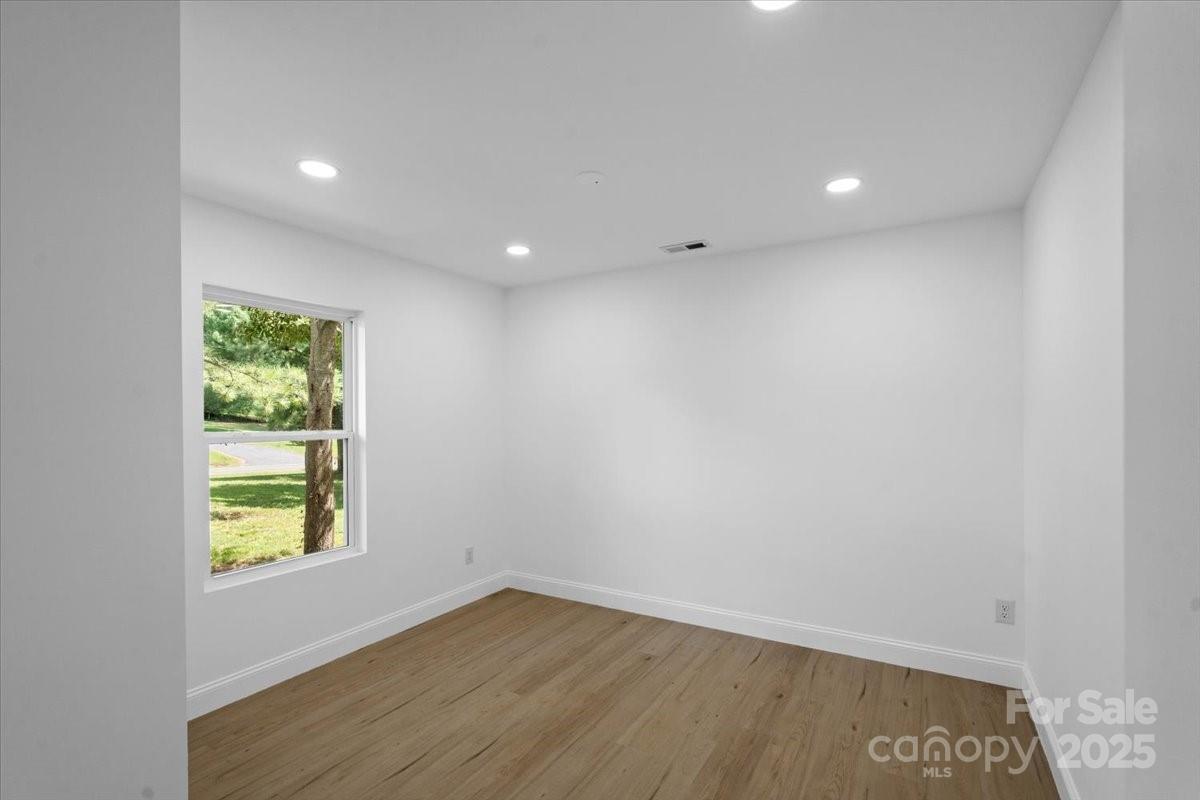 3156 Long Shoals Road Lincolnton, NC 28092 - Photo 11 of 21 a view of an empty room with wooden floor and a window