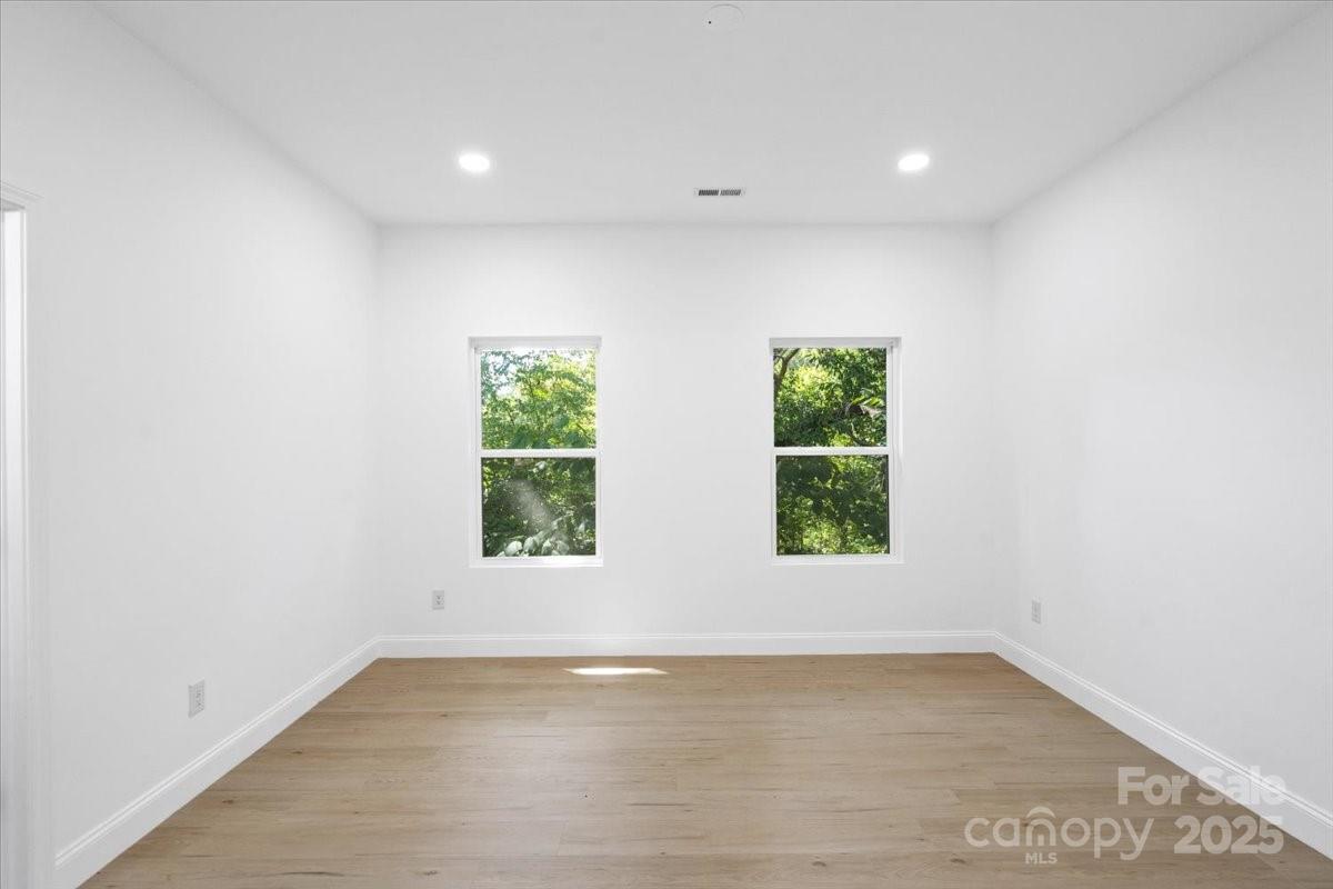 3156 Long Shoals Road Lincolnton, NC 28092 - Photo 13 of 21 an empty room with wooden floor and windows
