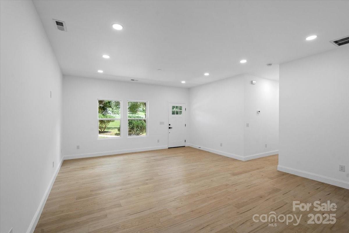 3156 Long Shoals Road Lincolnton, NC 28092 - Photo 6 of 21 an empty room with wooden floor and windows