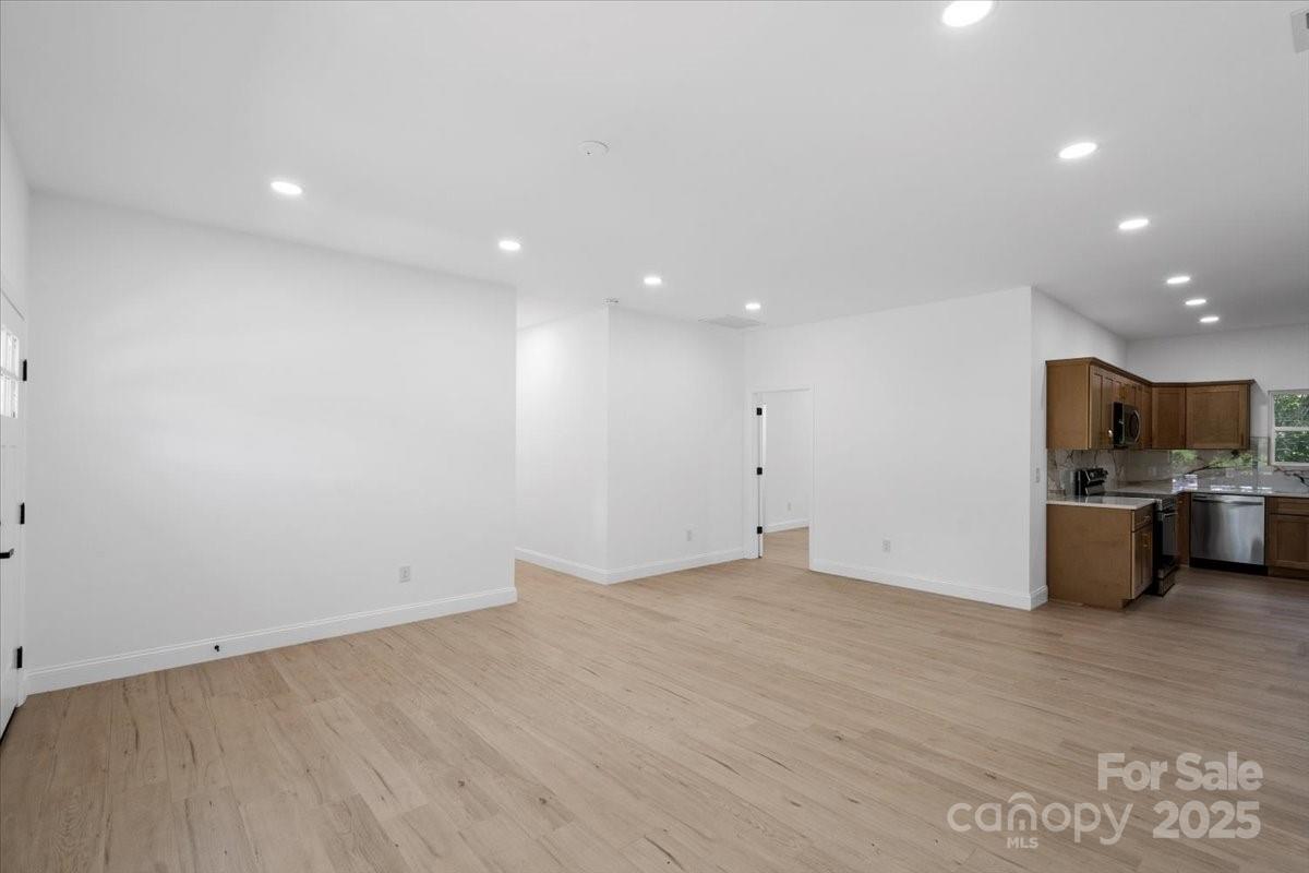 3156 Long Shoals Road Lincolnton, NC 28092 - Photo 7 of 21 a view of a kitchen with a sink and dishwasher a refrigerator with wooden floor