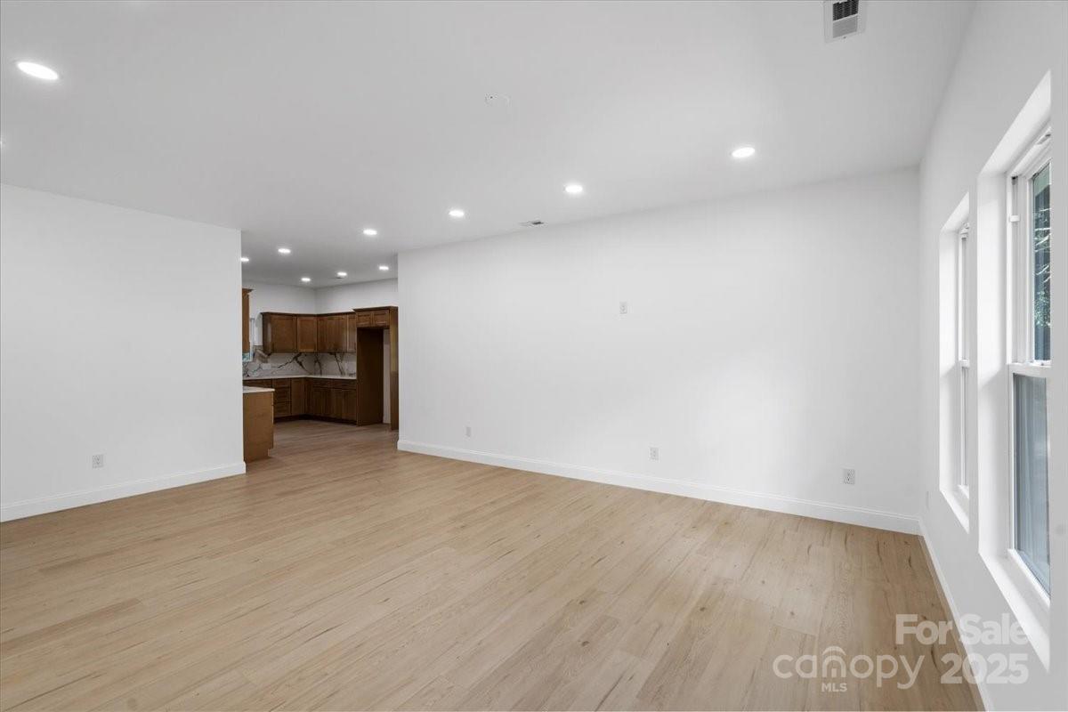 3156 Long Shoals Road Lincolnton, NC 28092 - Photo 8 of 21 an empty room with wooden floor and a window