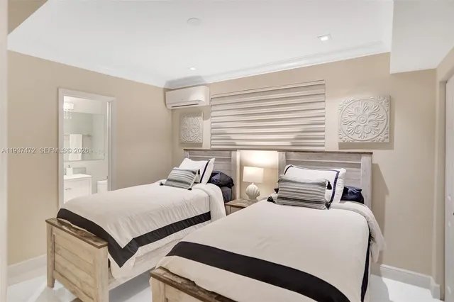 a bedroom with two beds and painting on the wall