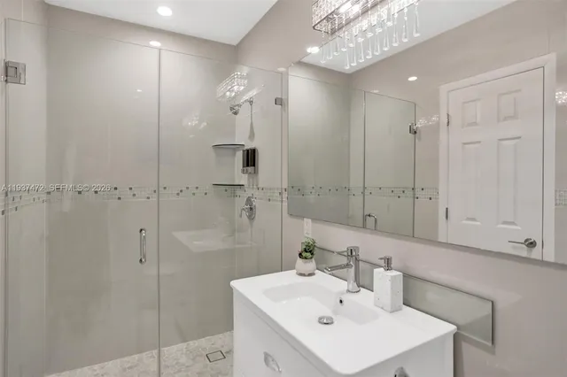 a bathroom with a sink a shower a mirror and a shower