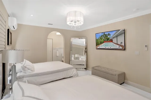 a bedroom with a bed and a chandelier