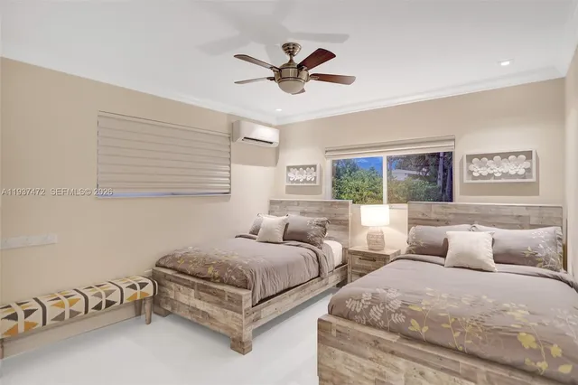 a bedroom with two beds and windows