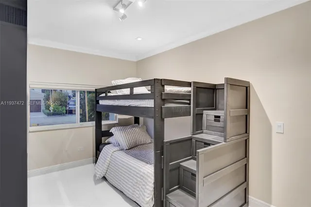 a bed room with a bed and glass walk in closet