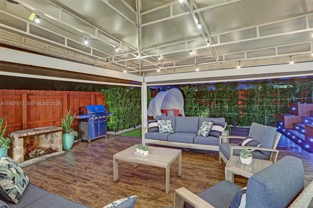 a living room with fireplace furniture and a large window