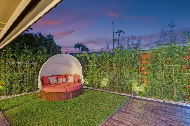 an aerial view of a house with garden space and street view