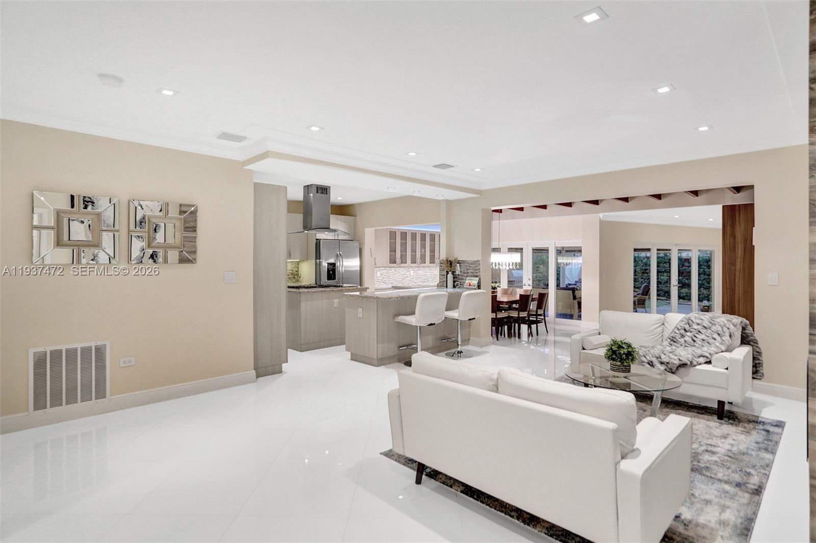 8843 Hawthorne Avenue Surfside, FL 33154 - Photo 8 of 28 a living room with furniture and a large window