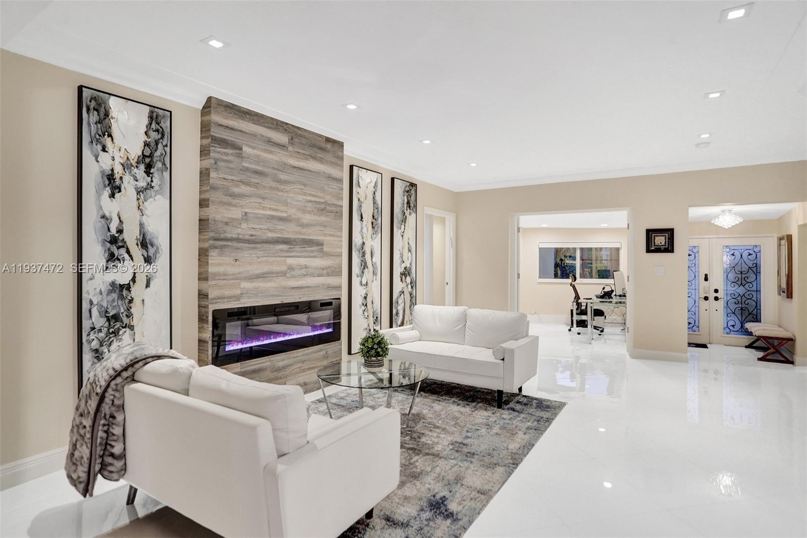 8843 Hawthorne Avenue Surfside, FL 33154 - Photo 9 of 28 a living room with furniture and a fireplace