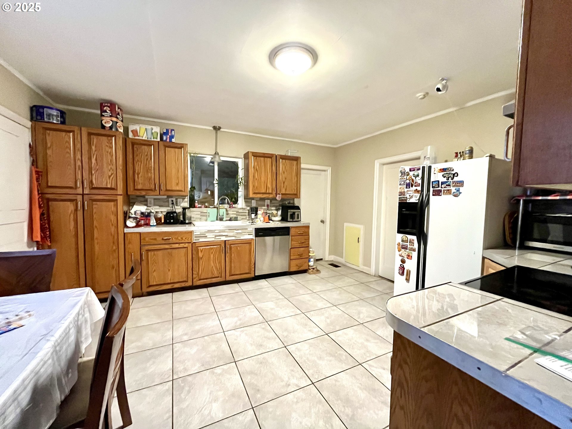 385 Southeast Twp Road Canby, OR 97013 - Photo 5 of 30 a kitchen with stainless steel appliances kitchen island granite countertop a sink cabinets and refrigerator