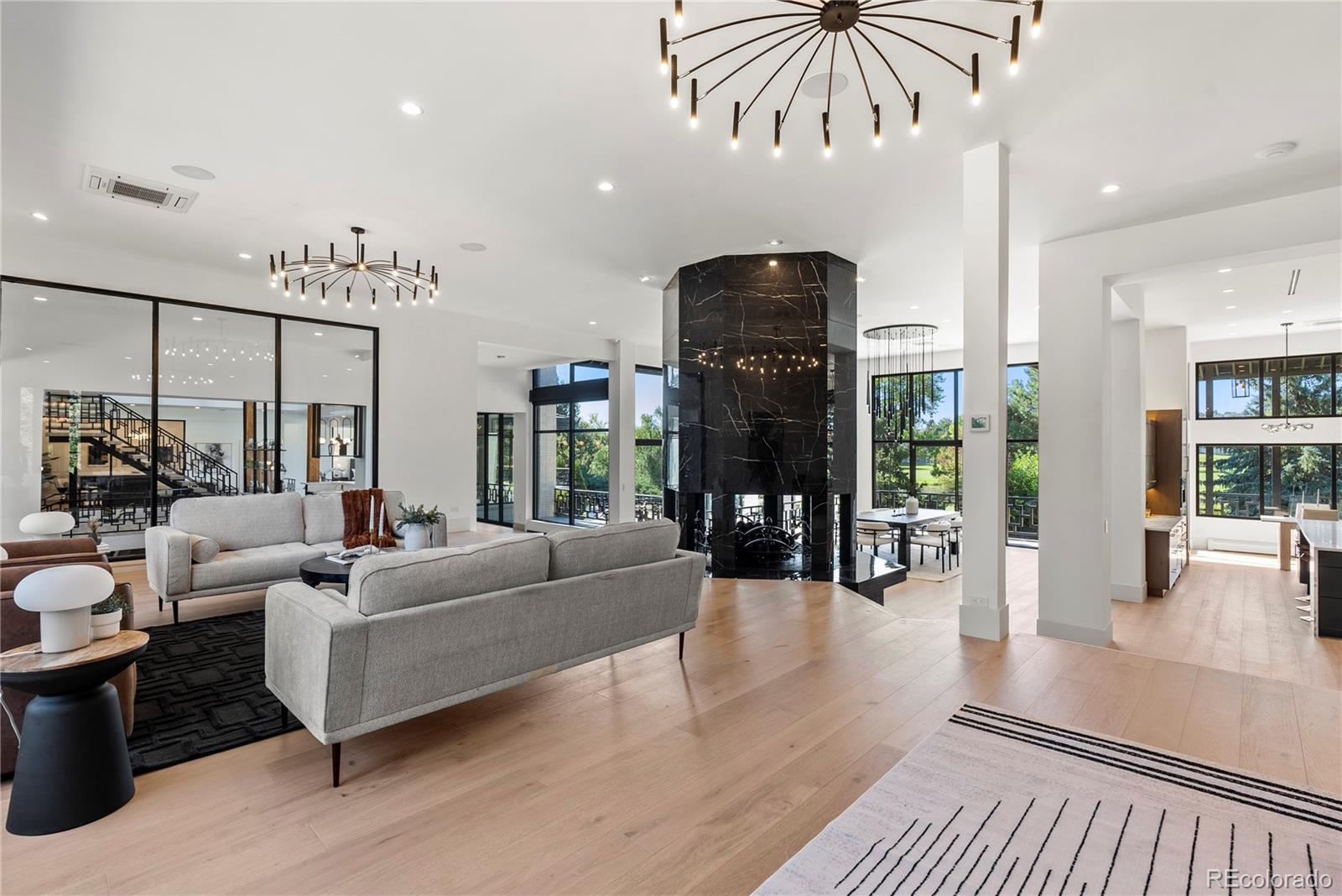 3962 South Chase Way Denver, CO 80235 - Photo 14 of 40 a living room with furniture and a chandelier