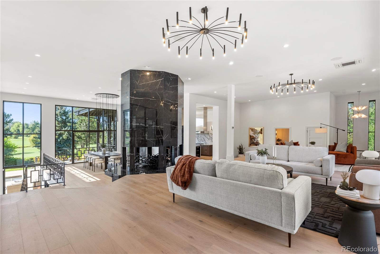 3962 South Chase Way Denver, CO 80235 - Photo 15 of 40 a living room with furniture a floor to ceiling window and a flat screen tv
