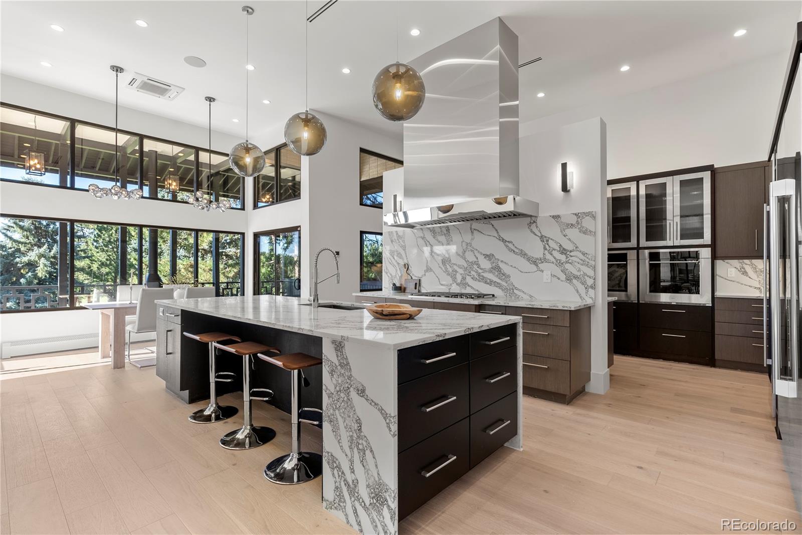 3962 South Chase Way Denver, CO 80235 - Photo 18 of 40 a kitchen with a stove kitchen island and stainless steel appliances