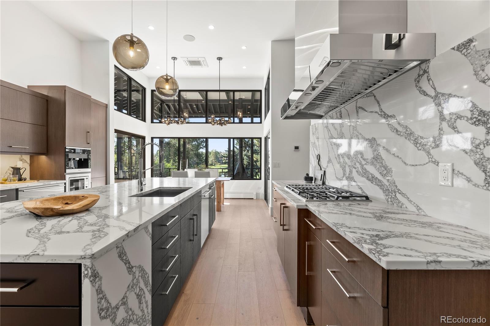 3962 South Chase Way Denver, CO 80235 - Photo 19 of 40 a kitchen with stainless steel appliances granite countertop a stove and a sink